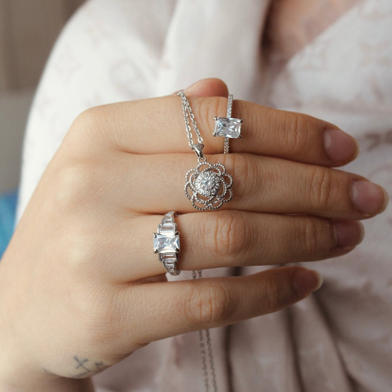 woman holding Elegance silver plated necklace with two rings Bella and Angelina Jr.- Regal Gems Jewellery